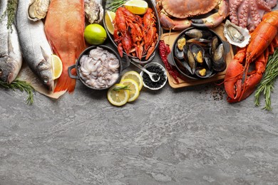 Photo of Many different sea food on grey table, top view