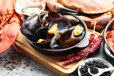 Photo of Many different sea food on grey table, closeup