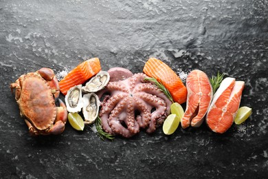 Many different sea food on dark table, top view