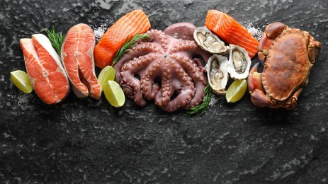 Photo of Many different sea food on dark table, top view