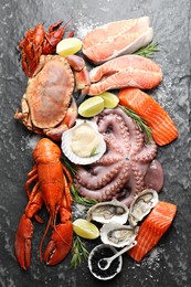 Photo of Many different sea food on dark table, top view