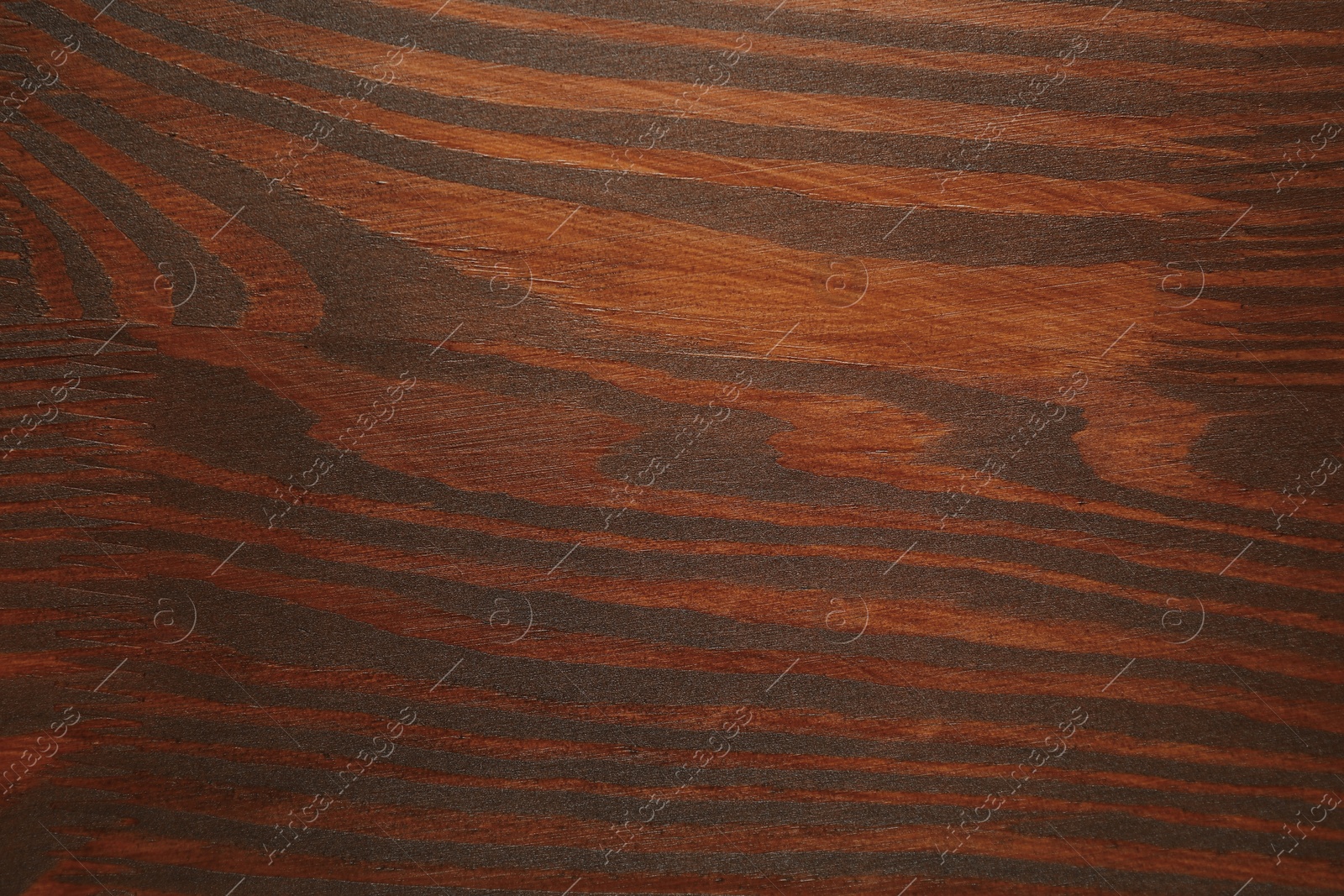 Photo of Applying walnut wood stain. Texture of wooden surface as background, top view