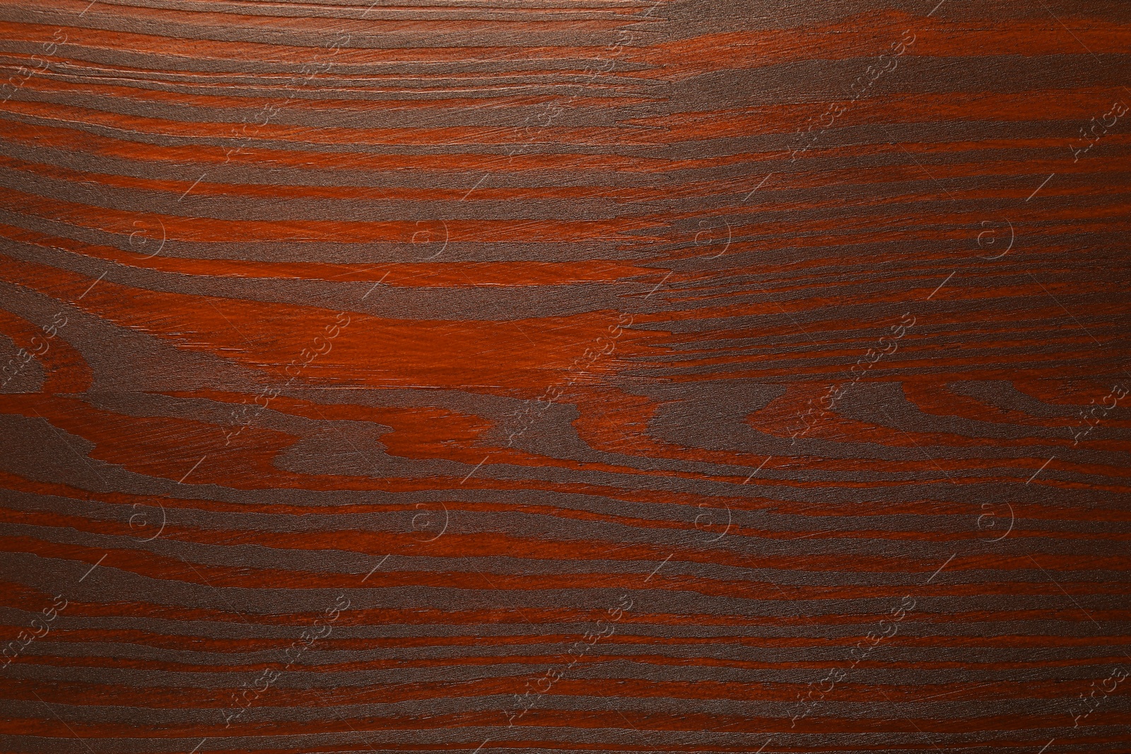 Photo of Texture of wooden surface after applying walnut wood stain as background, top view