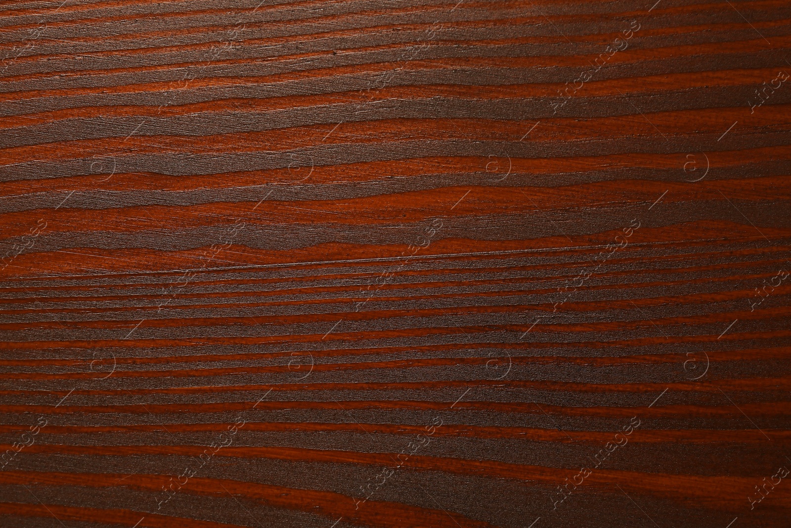 Photo of Texture of wooden surface after applying walnut wood stain as background, top view