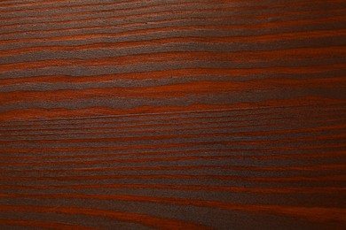 Photo of Texture of wooden surface after applying walnut wood stain as background, top view