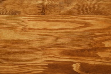 Photo of Applying walnut wood stain. Texture of wooden surface as background, top view