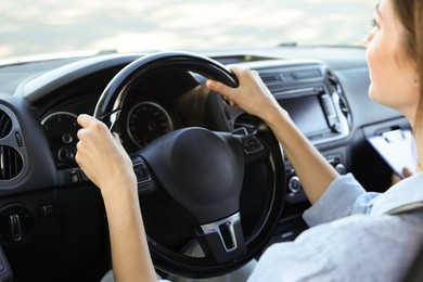 Photo of Driving school. Student passing driving test with examiner in car, closeup