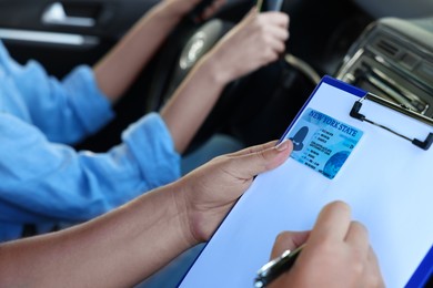 Driving school. Student passing driving test with examiner in car, closeup