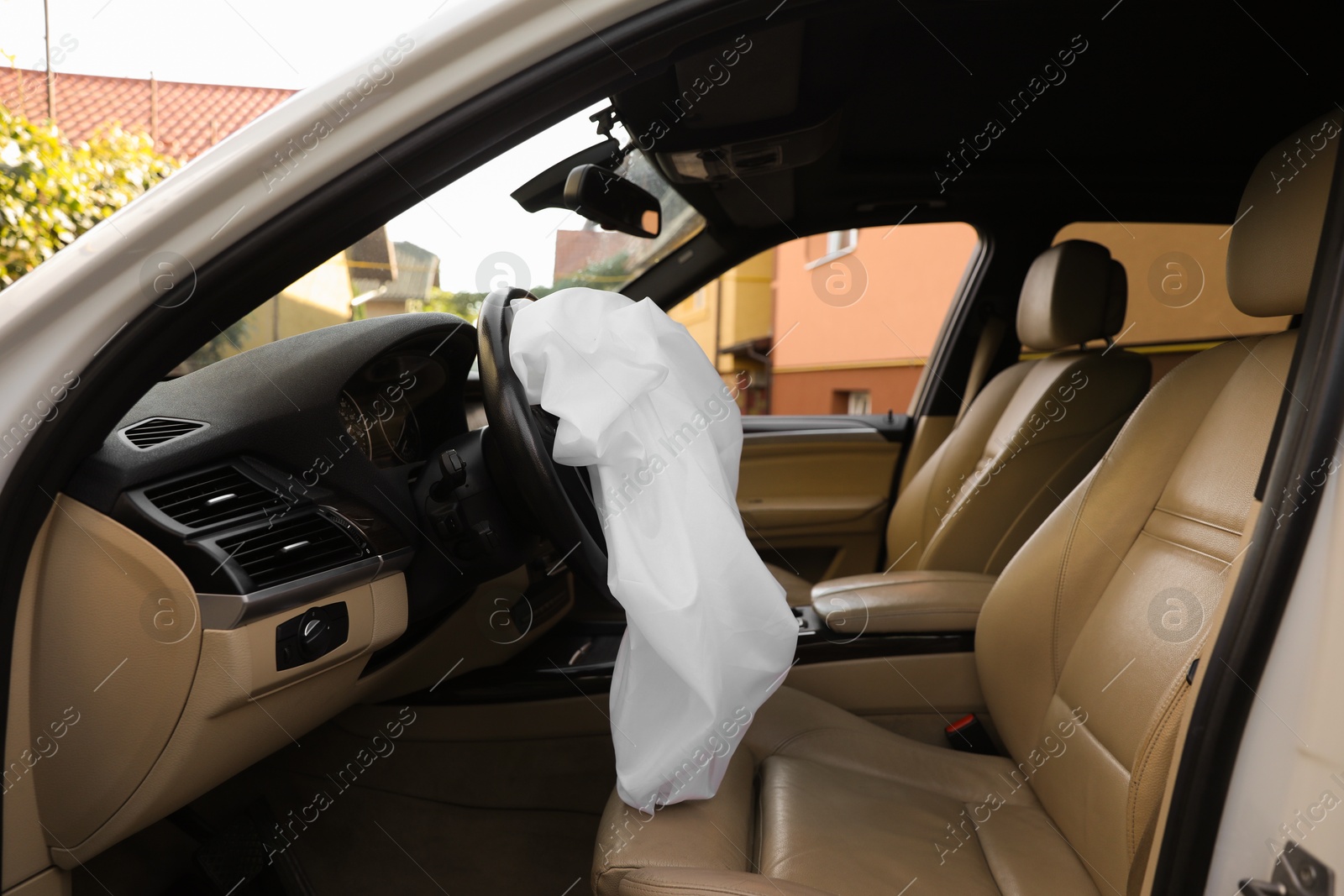 Photo of Opened airbag in automobile. Car safety equipment