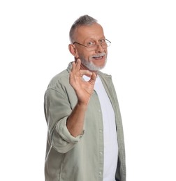 Photo of Portrait of handsome senior man showing ok gesture on white background