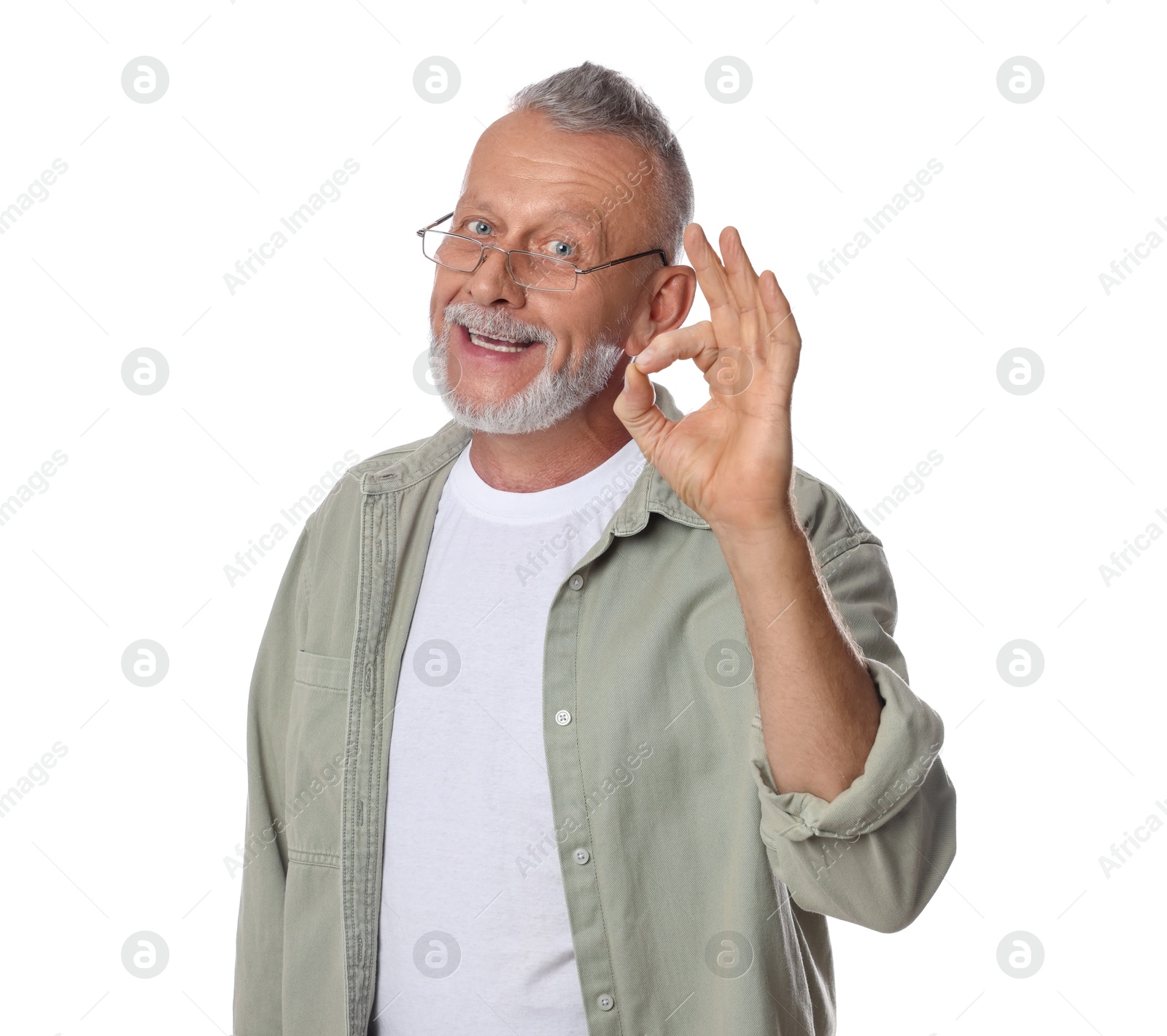 Photo of Portrait of smiling senior man showing ok gesture on white background