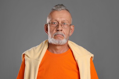 Portrait of handsome senior man on grey background