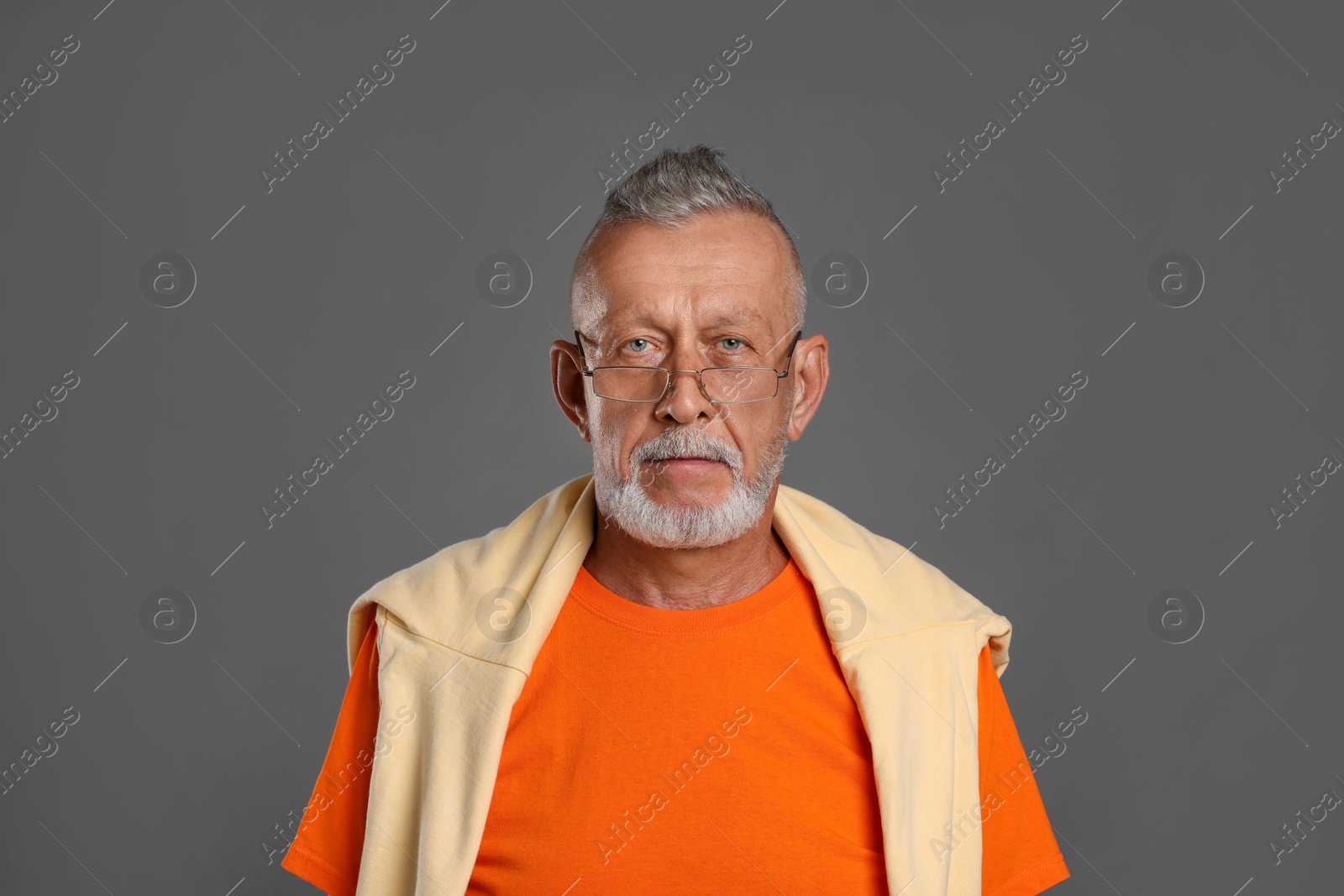 Photo of Portrait of handsome senior man on grey background