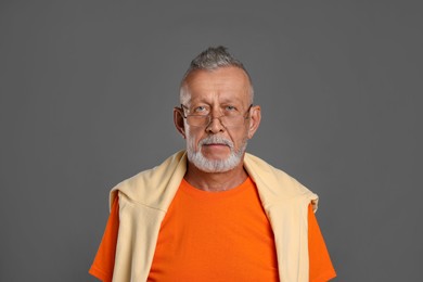 Portrait of handsome senior man on grey background