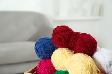 Skeins of soft yarn in crate indoors, closeup. Knitting material