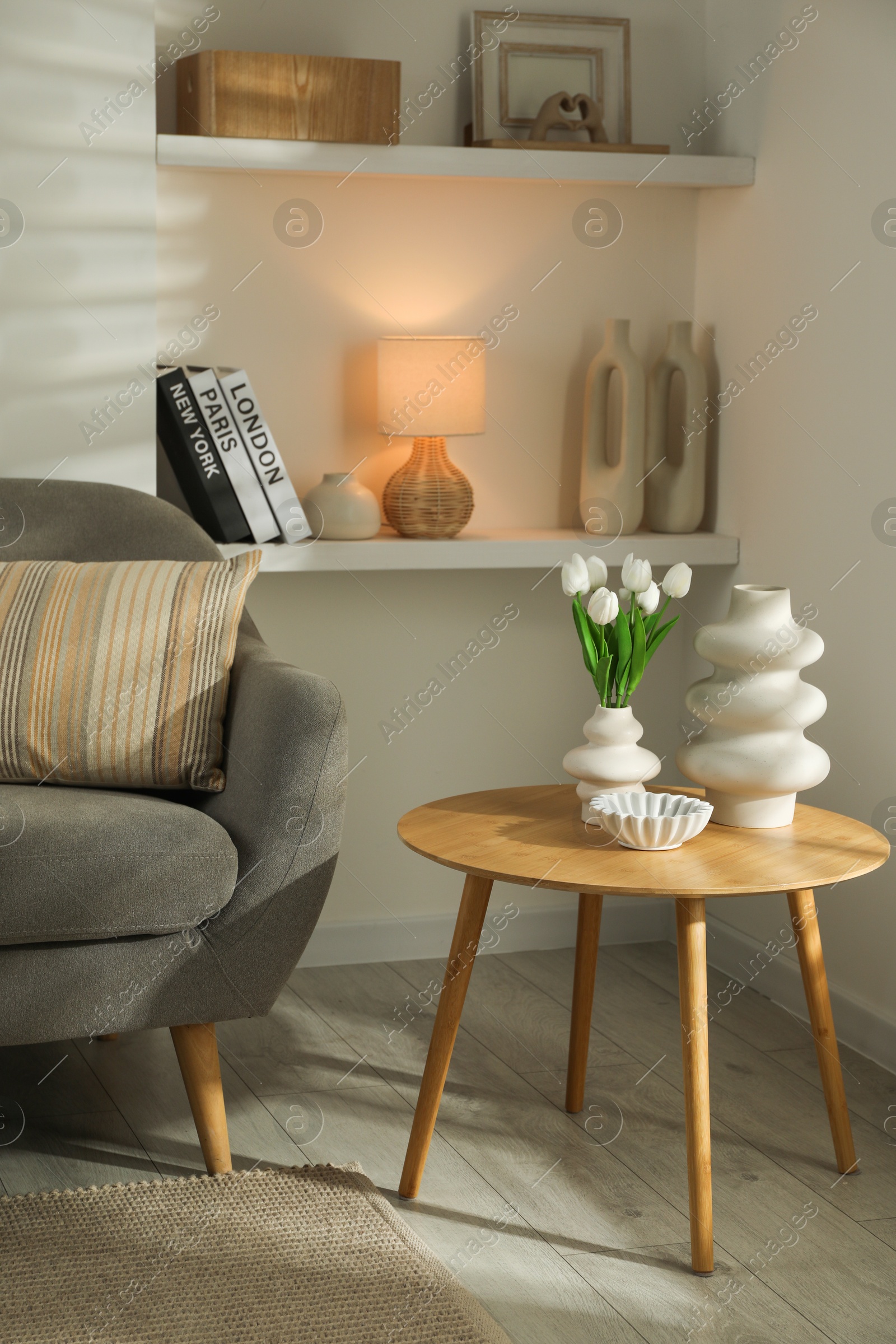 Photo of Sofa with soft cushion and coffee table in living room. Interior design