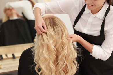 Photo of Hair cutting. Professional hairdresser working with client in salon, closeup