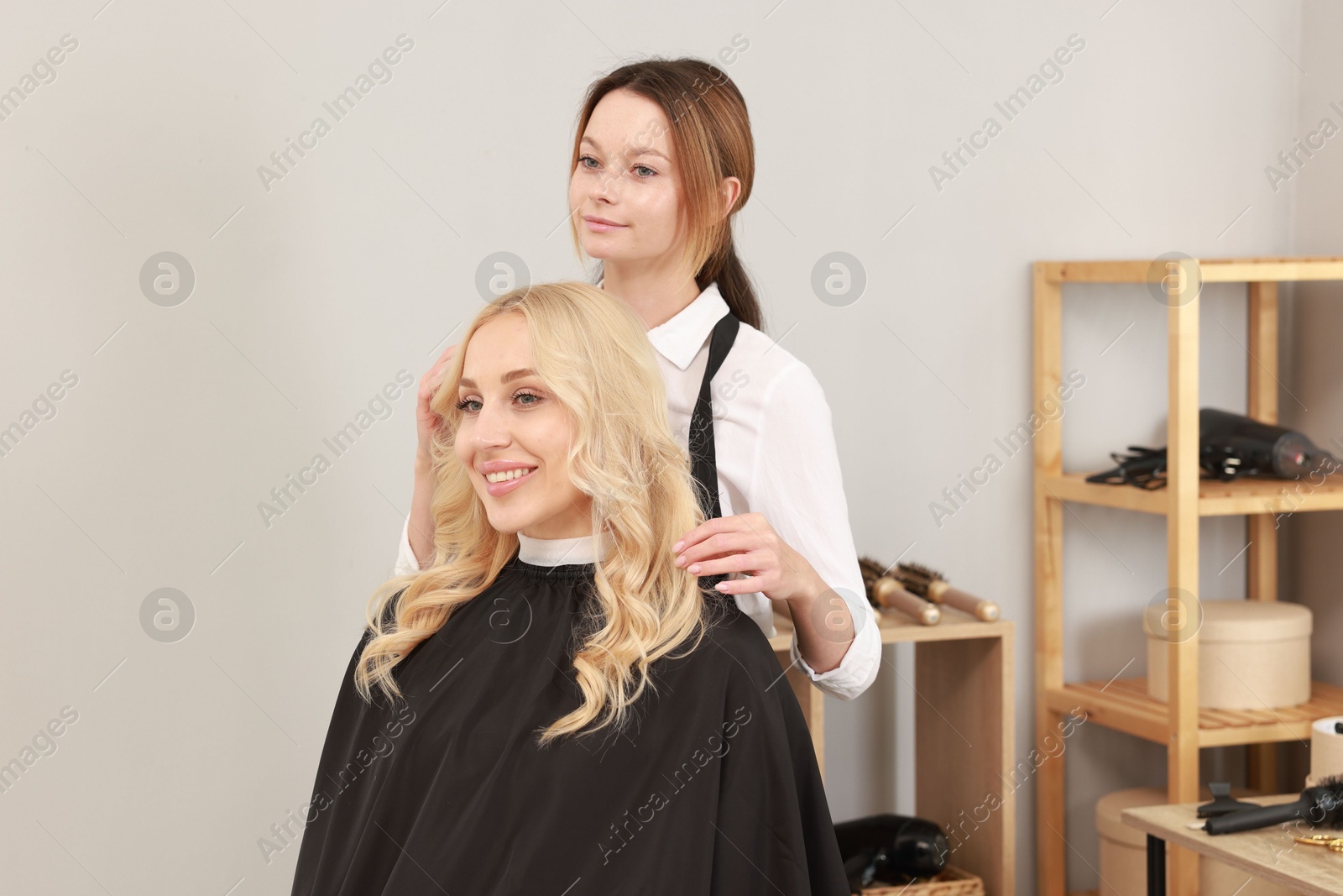 Photo of Hair cutting. Professional hairdresser working with client in salon