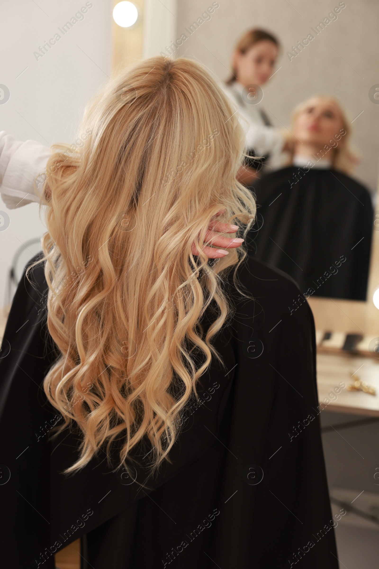 Photo of Hair cutting. Professional hairdresser working with client in salon, closeup