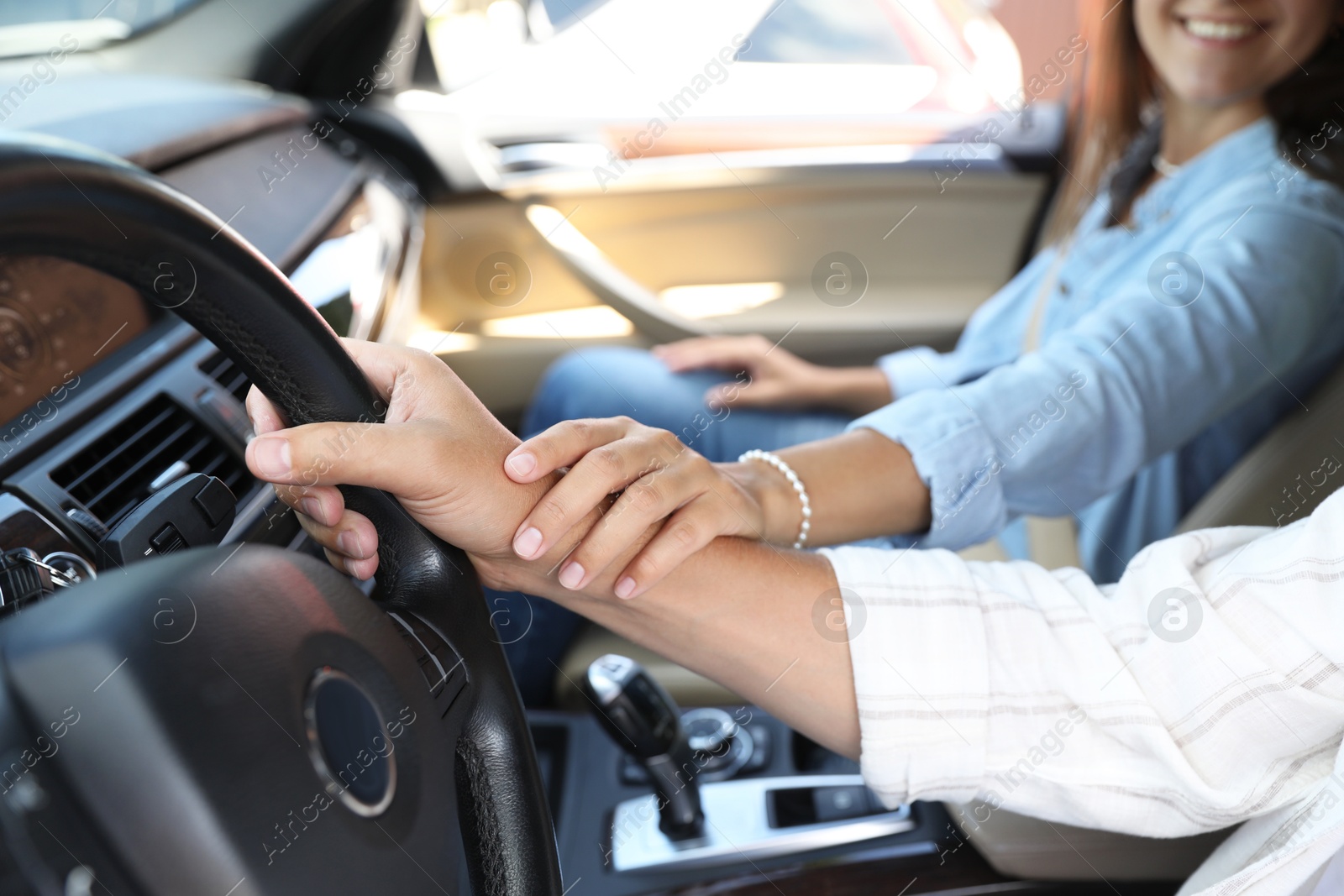 Photo of Lovely couple holding hands together while traveling by car, closeup