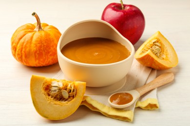 Photo of Delicious baby food in bowl and fresh ingredients on white wooden table