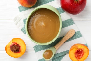 Photo of Delicious baby food in bowl and ingredients on white wooden table, flat lay