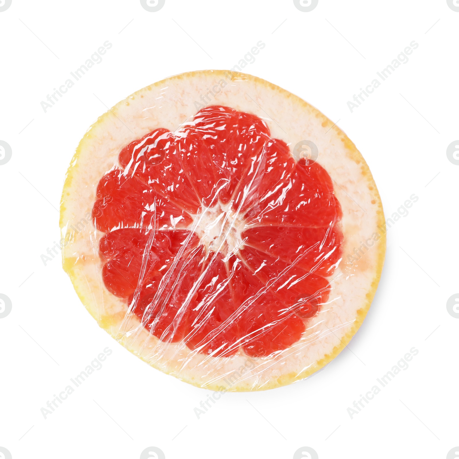 Photo of Half of grapefruit with plastic food wrap isolated on white, top view