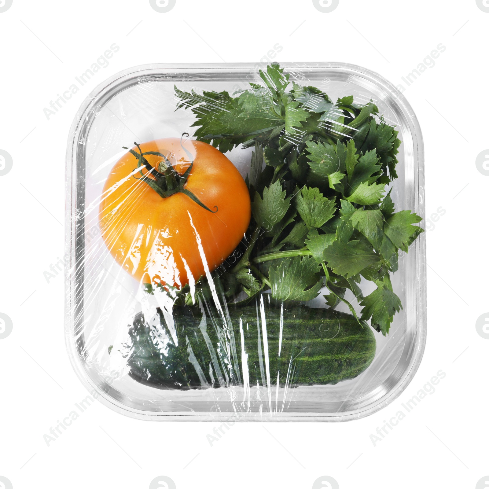 Photo of Glass container of fresh vegetables with plastic food wrap isolated on white, top view