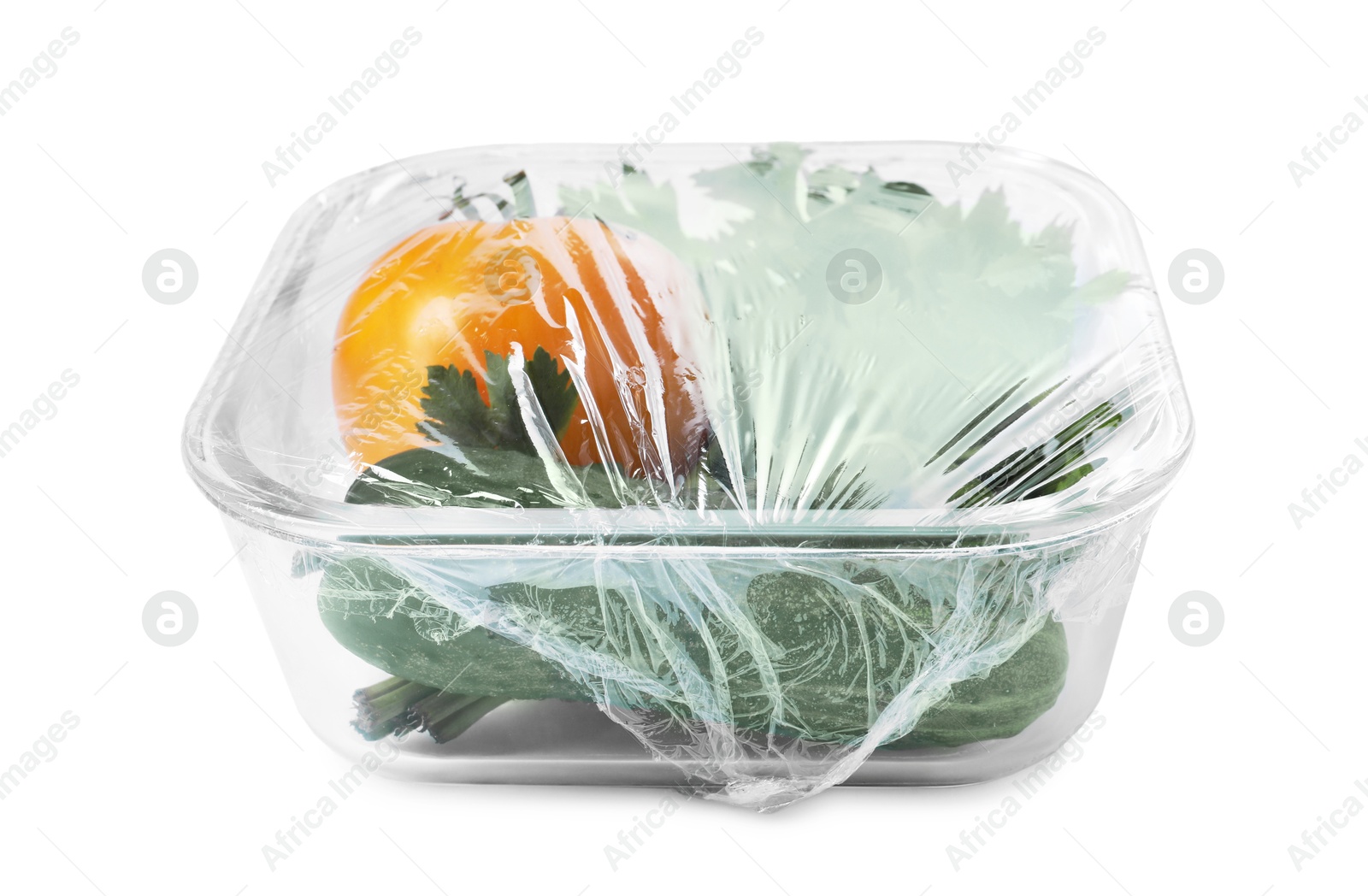 Photo of Glass container of fresh vegetables with plastic food wrap isolated on white