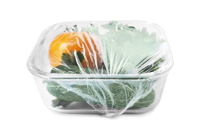 Photo of Glass container of fresh vegetables with plastic food wrap isolated on white