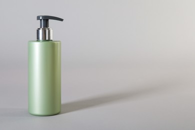 Bottle of shampoo on light background. Space for text