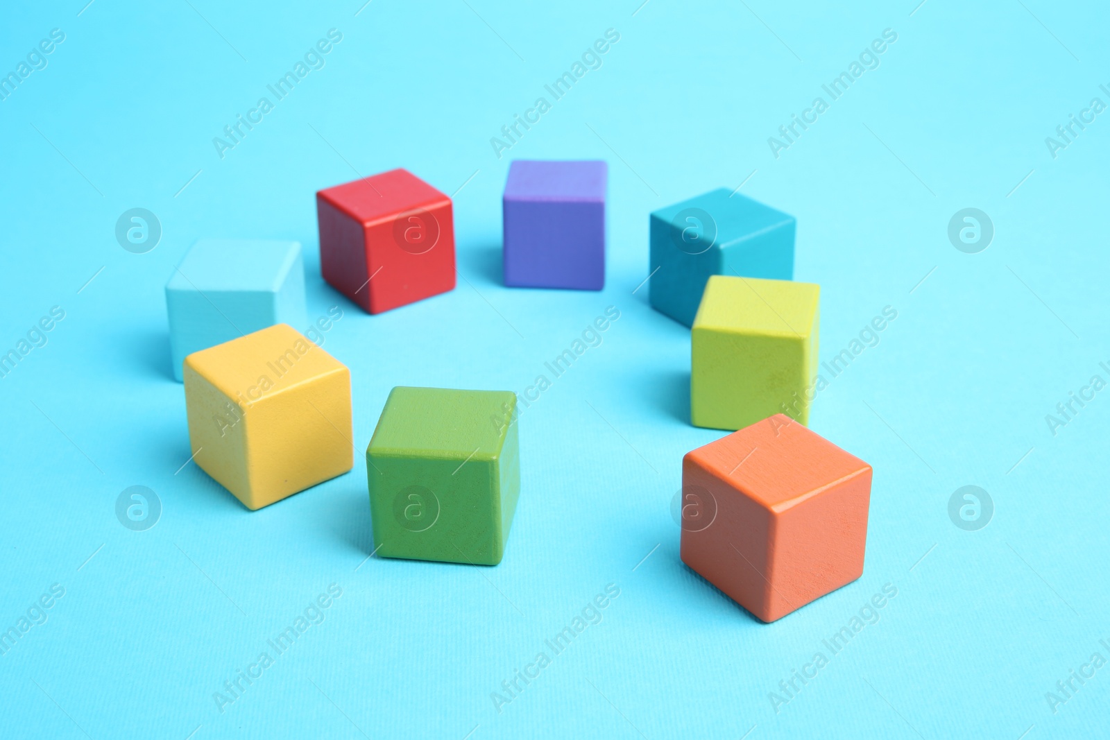 Photo of Many colorful cubes on light blue background