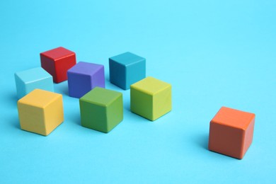 Photo of Many colorful cubes on light blue background