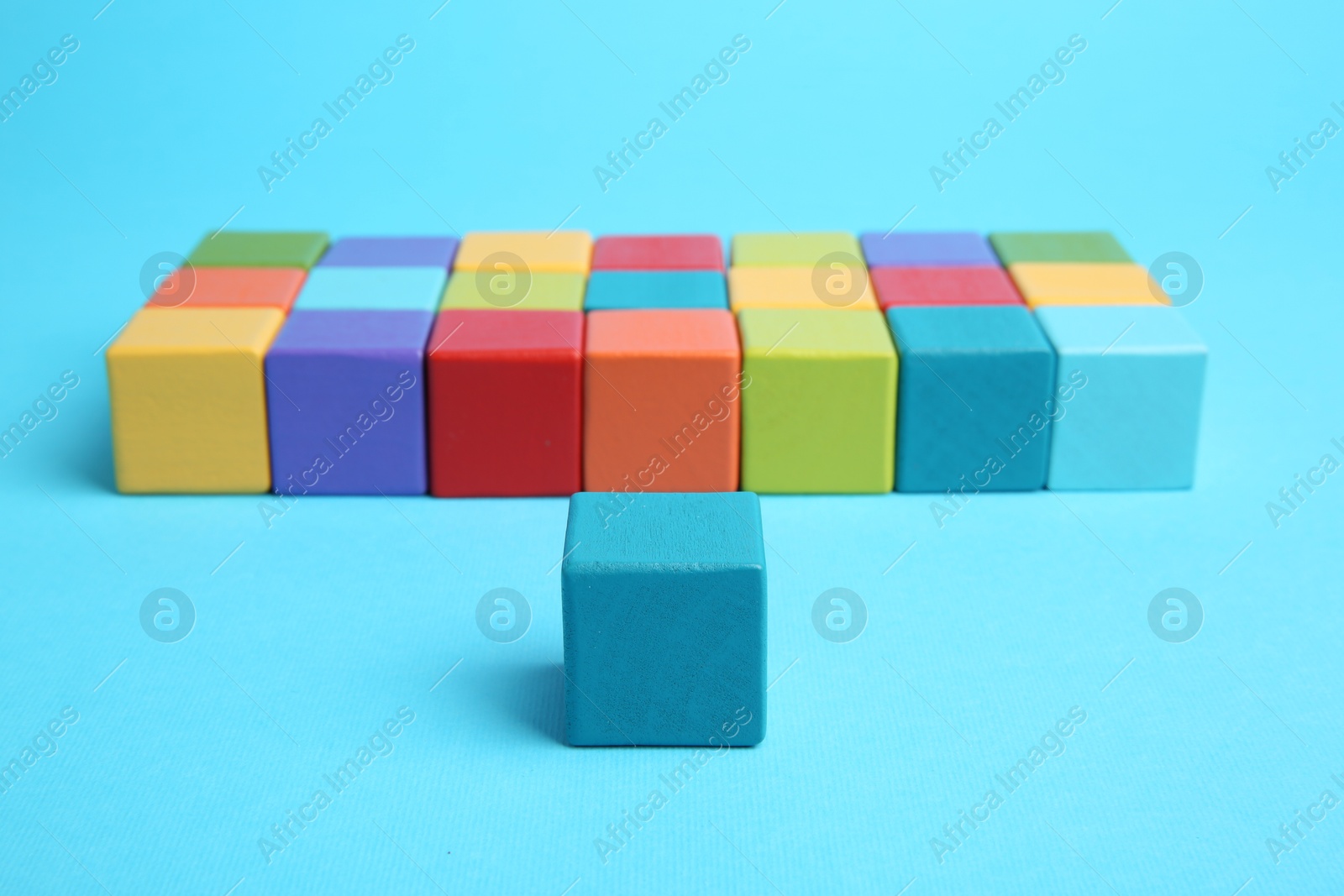 Photo of Many colorful cubes on light blue background