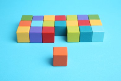 Photo of Many colorful cubes on light blue background