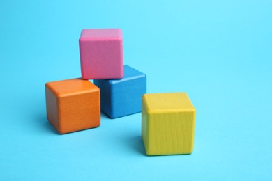 Photo of Many colorful cubes on light blue background