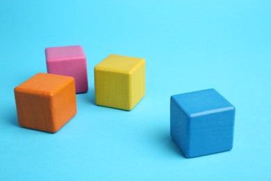 Photo of Many colorful cubes on light blue background