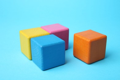 Photo of Many colorful cubes on light blue background