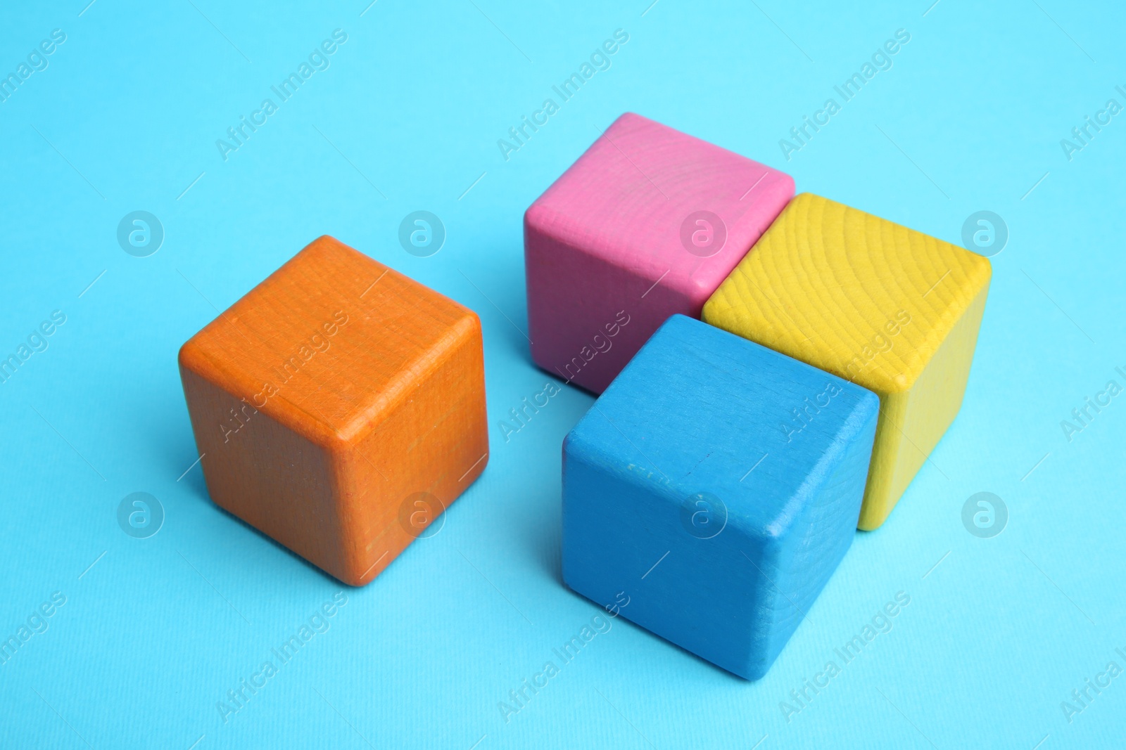 Photo of Many colorful cubes on light blue background