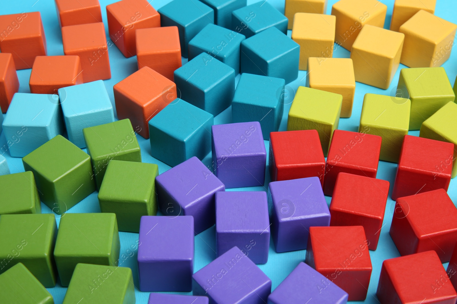 Photo of Many colorful cubes on light blue background