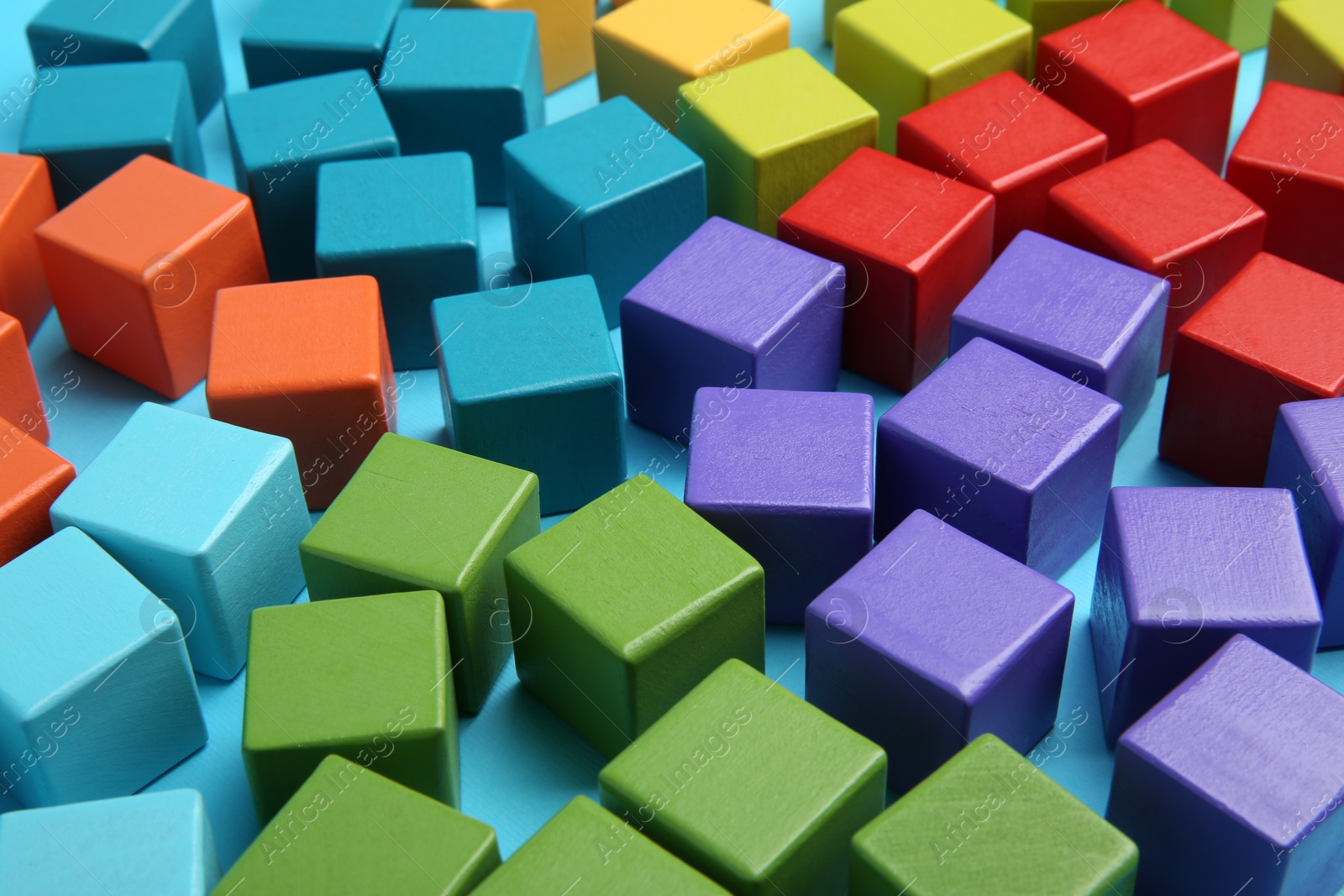 Photo of Many colorful cubes on light blue background