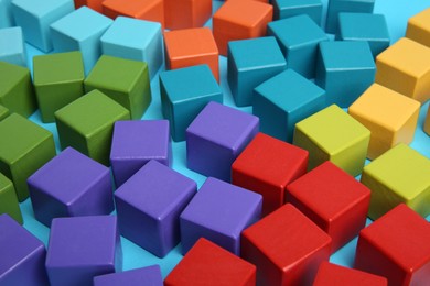 Photo of Many colorful cubes on light blue background