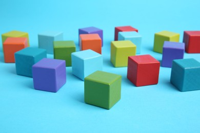 Photo of Many colorful cubes on light blue background