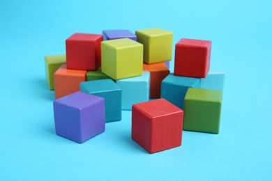 Photo of Many colorful cubes on light blue background