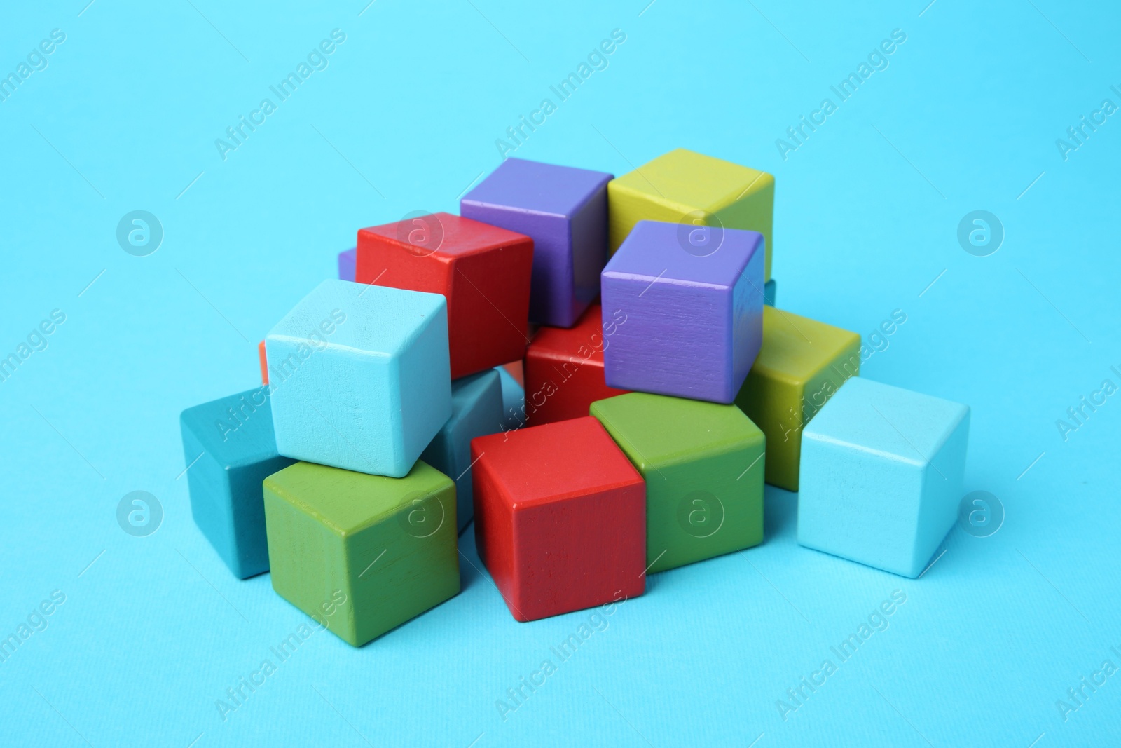 Photo of Many colorful cubes on light blue background