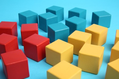 Photo of Many colorful cubes on light blue background