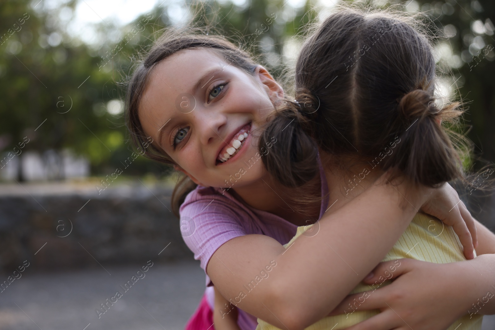 Photo of Portrait of cute little sisters in park