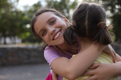 Photo of Portrait of cute little sisters in park