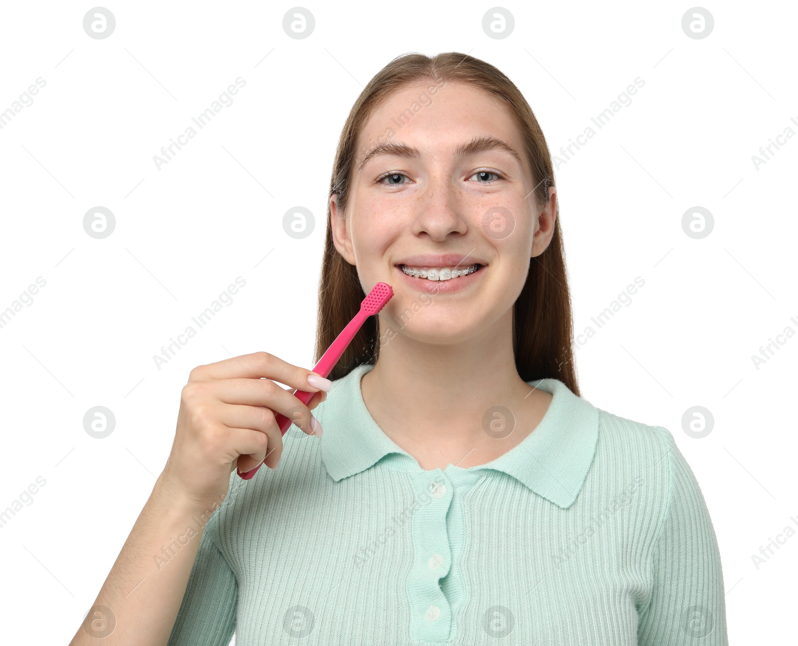 Photo of Girl with braces holding toothbrush on white background