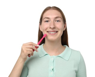 Photo of Girl with braces holding toothbrush on white background